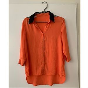 Bright orange and black blouse